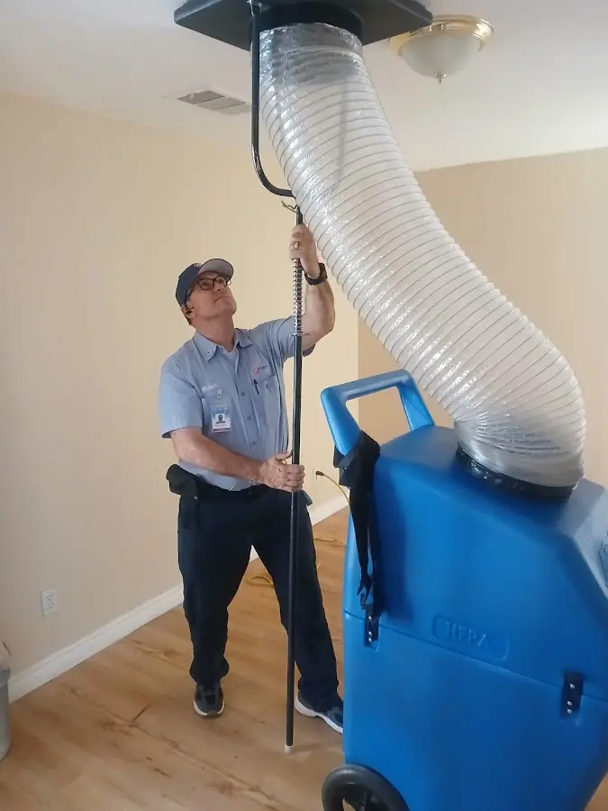 Furnace Tune-Up technician using HEPA equipment in Weslaco